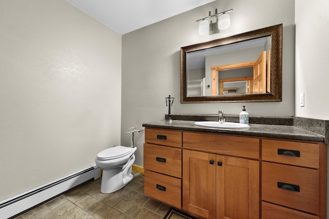 bathroom featuring vanity, toilet, and a baseboard heating unit