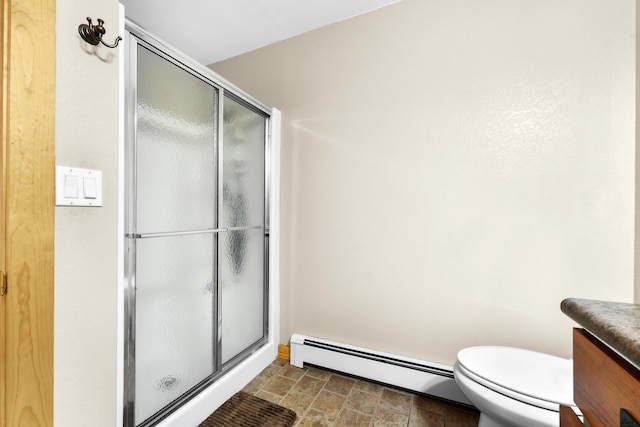 bathroom featuring vanity, a baseboard radiator, toilet, and a shower with shower door