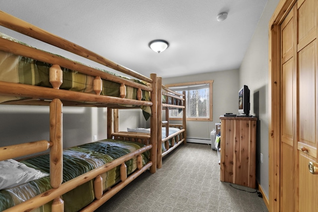 carpeted bedroom with a closet and a baseboard heating unit