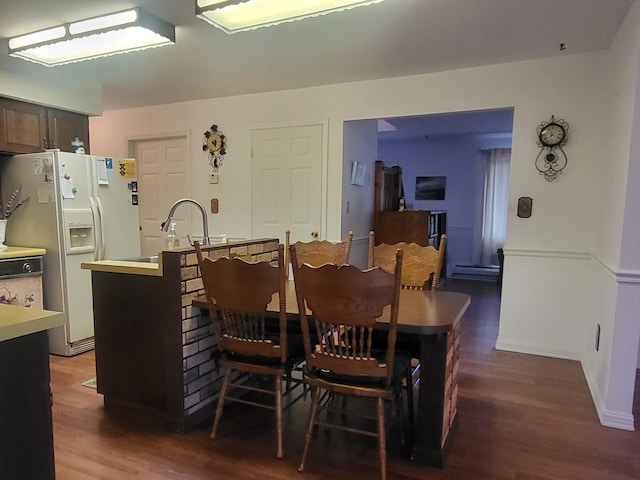 dining area featuring a baseboard radiator and dark hardwood / wood-style flooring