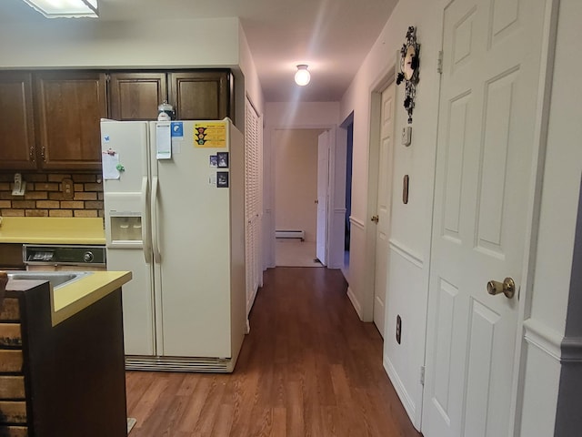 kitchen featuring dark brown cabinetry, light hardwood / wood-style floors, backsplash, white refrigerator with ice dispenser, and a baseboard heating unit