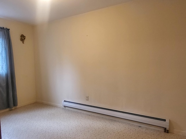 unfurnished room featuring a baseboard heating unit