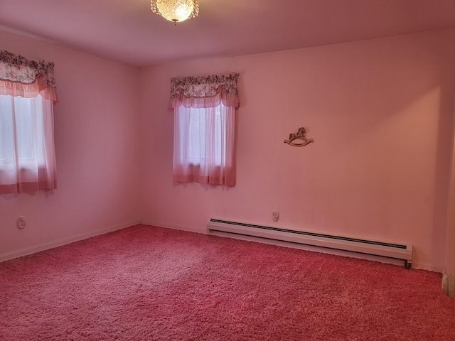 carpeted spare room featuring a baseboard radiator