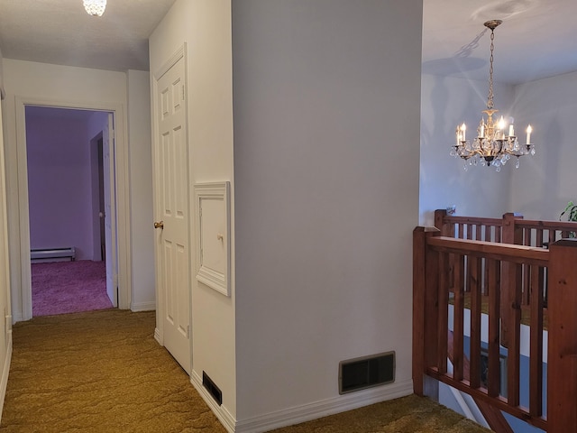 hall featuring a baseboard heating unit, carpet floors, and a notable chandelier