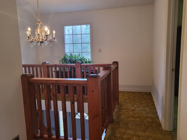 stairs with a notable chandelier and carpet floors