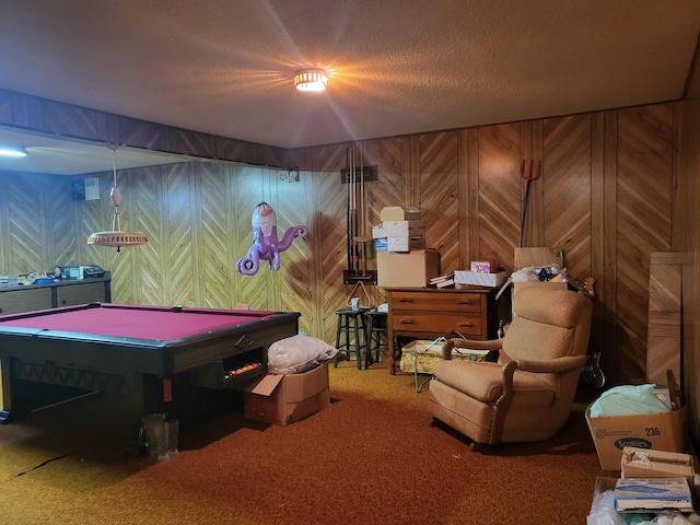 playroom with wooden walls, pool table, a textured ceiling, and carpet floors