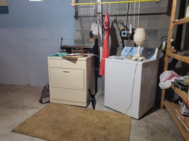 clothes washing area with washer and clothes dryer