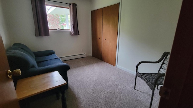 sitting room with light carpet and baseboard heating