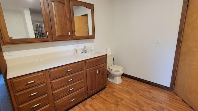 bathroom featuring hardwood / wood-style floors, vanity, and toilet