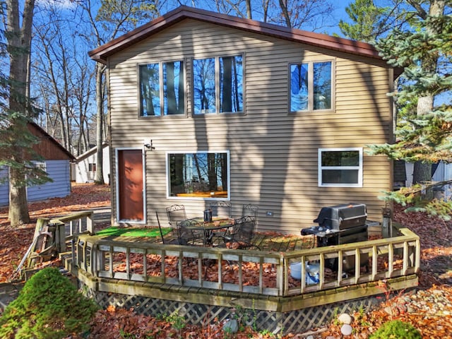 rear view of house featuring a wooden deck