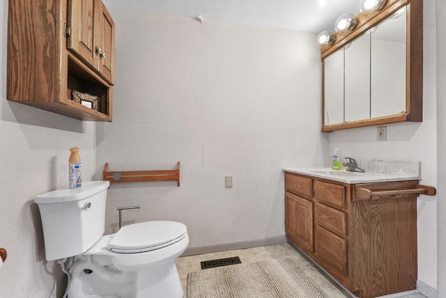 bathroom featuring toilet and vanity