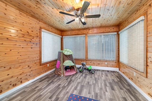 rec room featuring wooden ceiling, wood walls, and hardwood / wood-style flooring