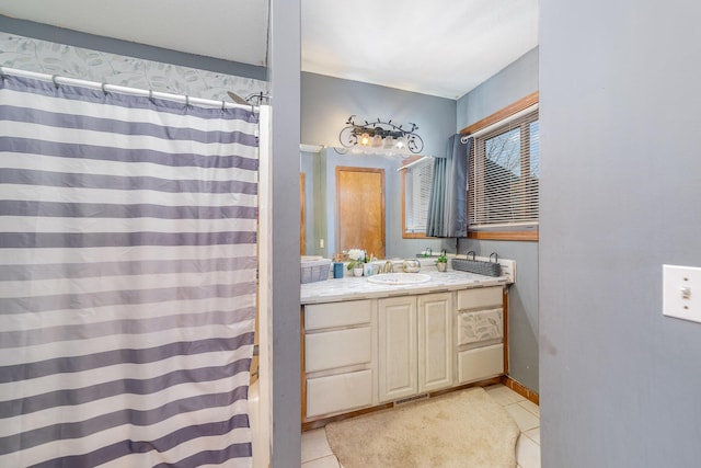 bathroom with tile patterned flooring, a shower with shower curtain, and vanity