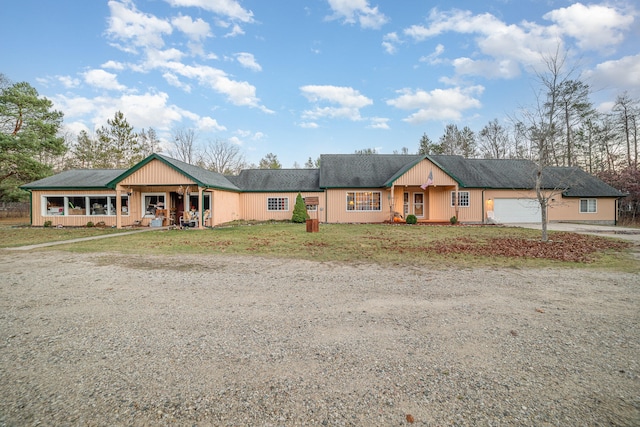 ranch-style house with a porch and a garage