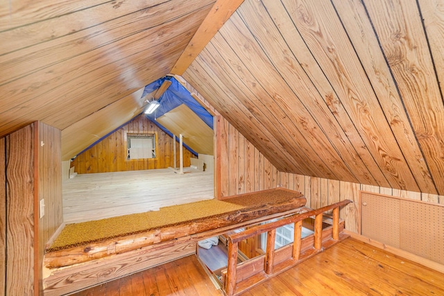 additional living space featuring wooden ceiling, wood walls, light wood-type flooring, and vaulted ceiling