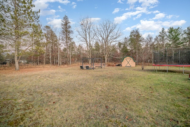 view of yard with a storage shed and a trampoline