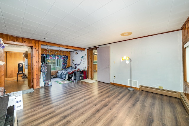 interior space with wooden walls, ornamental molding, and dark wood-type flooring