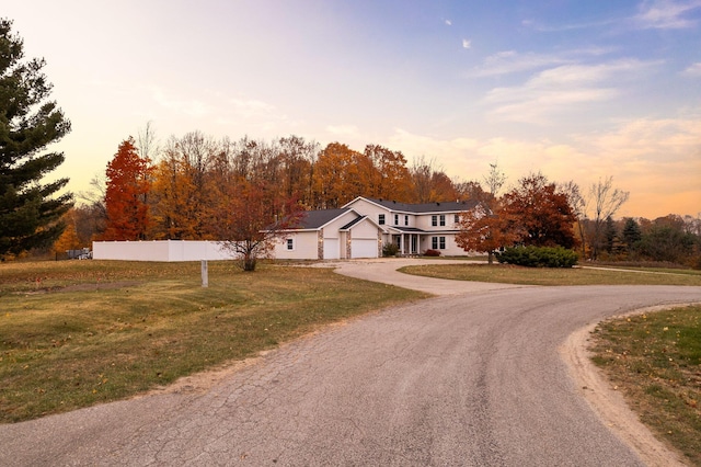 view of front of house featuring a garage and a yard