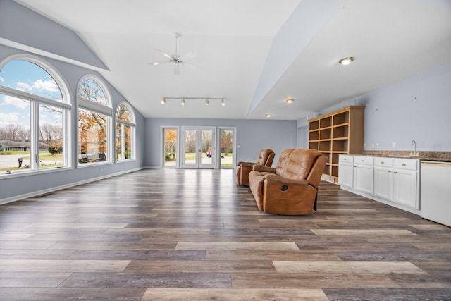 living room featuring vaulted ceiling, ceiling fan, dark wood-type flooring, and sink