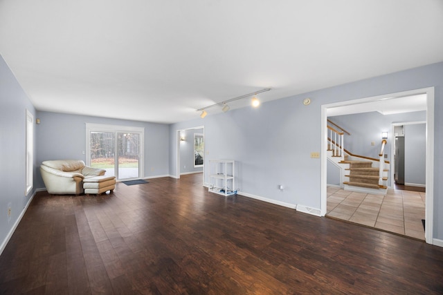 unfurnished room featuring hardwood / wood-style floors and rail lighting