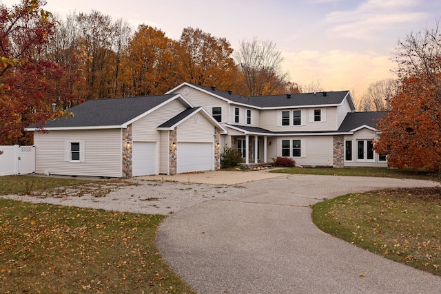 view of front of home with a garage and a yard