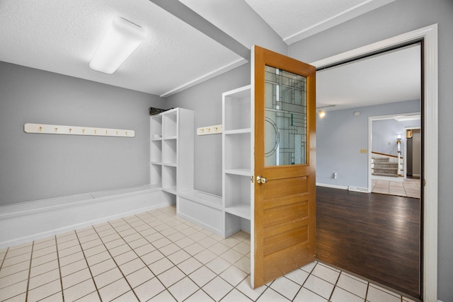 bathroom with wood-type flooring and a textured ceiling