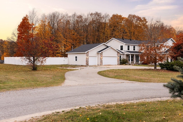 view of front of house featuring a lawn and a garage