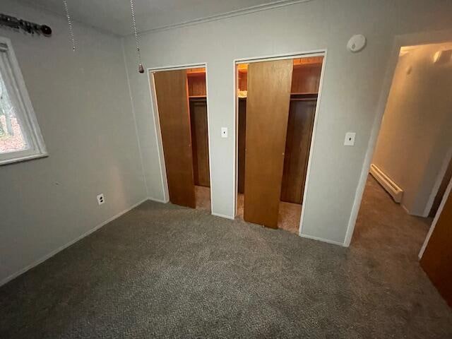 unfurnished bedroom with dark carpet