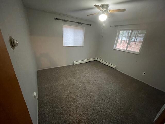 empty room with ceiling fan, a baseboard radiator, and dark carpet