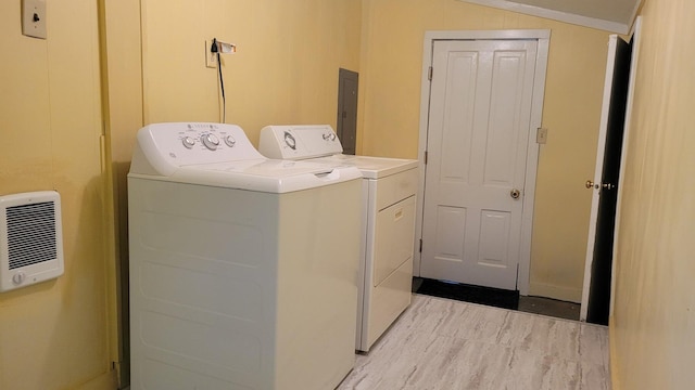 laundry area with washer and clothes dryer and heating unit