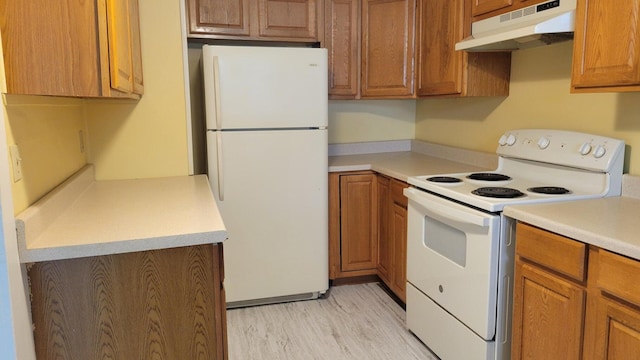 kitchen featuring light hardwood / wood-style flooring and white appliances