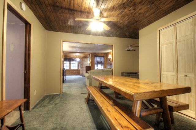 carpeted dining room featuring ceiling fan and wooden ceiling