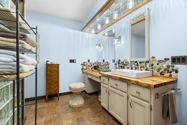 bathroom with vanity and decorative backsplash