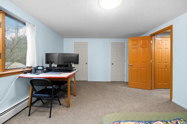 office space with a textured ceiling, light colored carpet, and a baseboard radiator