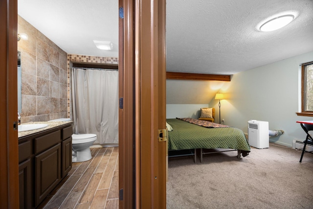 bedroom with tile walls, vaulted ceiling with beams, a textured ceiling, dark hardwood / wood-style flooring, and a baseboard heating unit