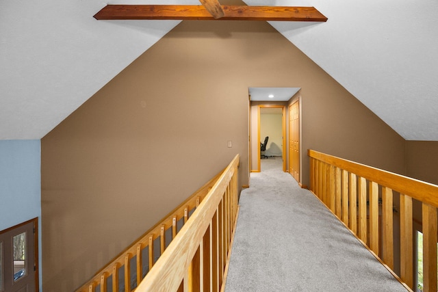 hallway with lofted ceiling with beams and light carpet