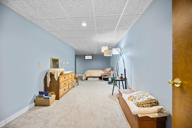 bedroom featuring a paneled ceiling and carpet