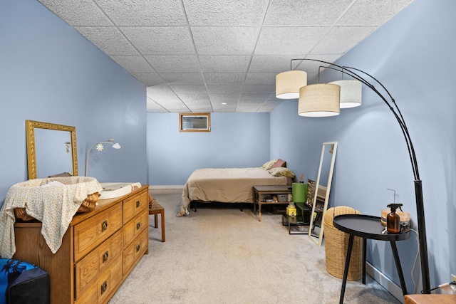 carpeted bedroom featuring a paneled ceiling