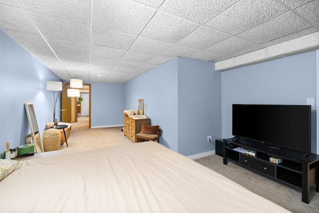 carpeted bedroom with a drop ceiling