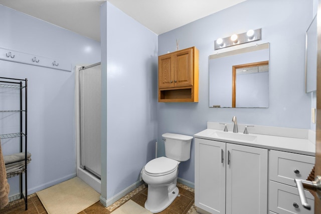 bathroom featuring a shower with door, vanity, toilet, and tile patterned floors