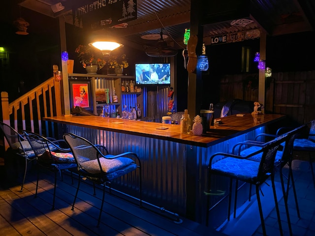 bar with hardwood / wood-style floors