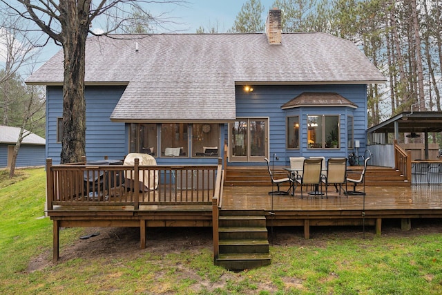 back of house with a lawn and a wooden deck