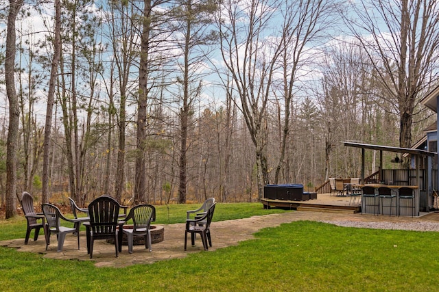 view of yard featuring a hot tub, a patio area, and a deck