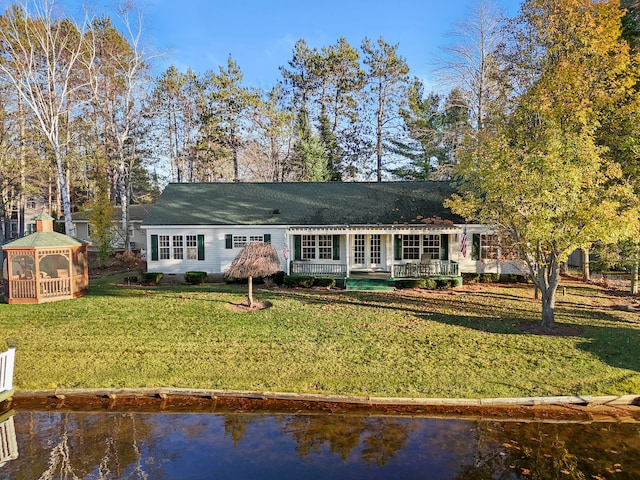 ranch-style house with a gazebo, a front lawn, and a water view