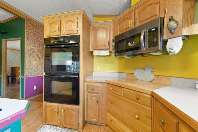 kitchen with a textured ceiling, light wood-type flooring, crown molding, and double oven