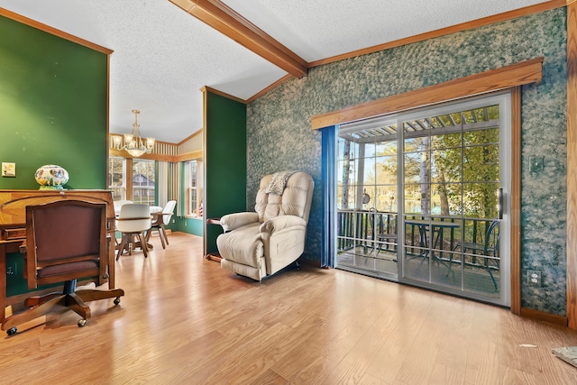 living area featuring a chandelier, hardwood / wood-style floors, lofted ceiling with beams, and a wealth of natural light