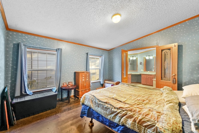 bedroom featuring dark hardwood / wood-style floors, ornamental molding, and a textured ceiling