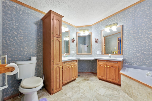 bathroom with toilet, vanity, a textured ceiling, and ornamental molding