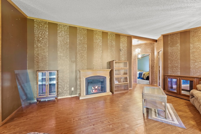 living room with wood-type flooring and a textured ceiling