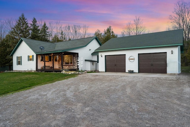 ranch-style home featuring a yard and a garage